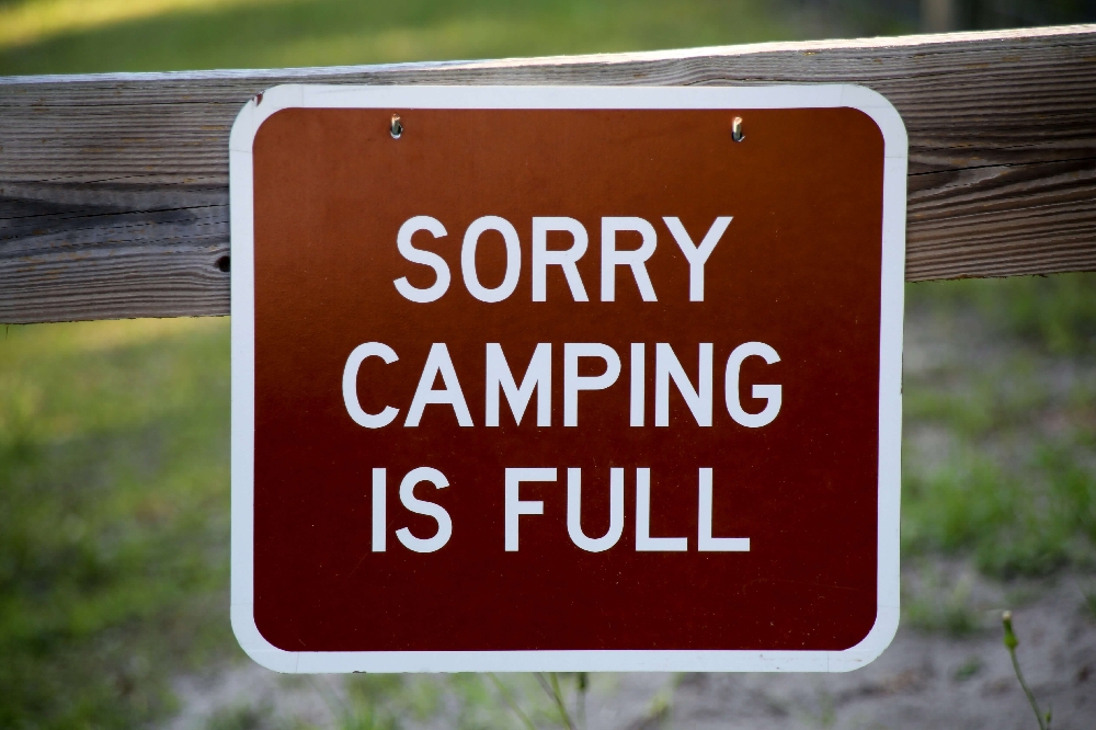 Sorry camping is full sign at campground entrance showing high demand from upgraded amenities